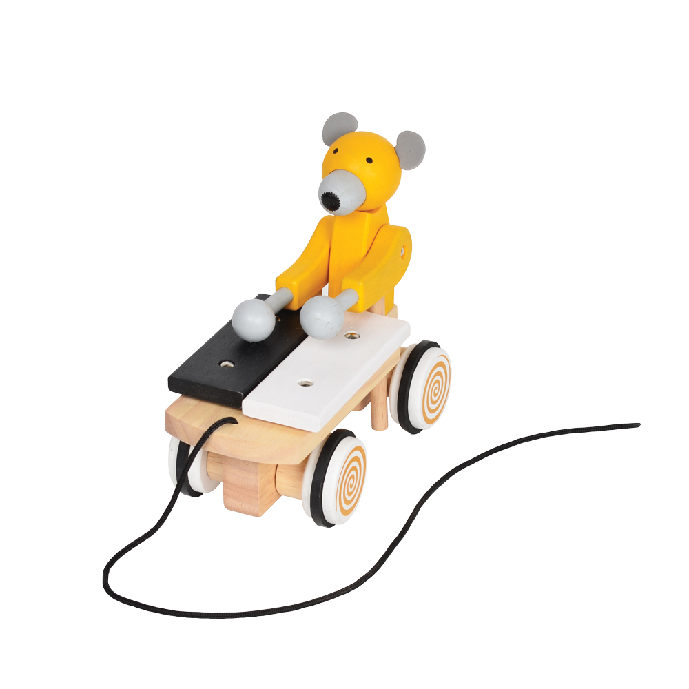 A colorful toy xylophone in the shape of a cartoon bear with yellow body and black hair, attached to a wooden structure resembling a stomach and intestines, on a spiral-patterned base.