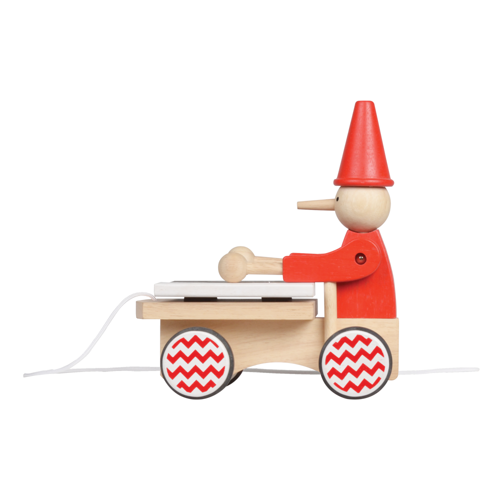 A wooden pull-along toy featuring a character resembling Pinocchio with a red hat, red jacket,  attached to a small wooden xylophone on wheels with a red and white zig-zag pattern.