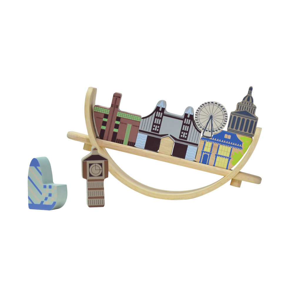A London cityscape-themed balancing toy featuring famous landmarks. Children can arrange and balance the landmark pieces on a crescent-shaped base that rocks gently with each placement, enhancing coordination and concentration skills.
