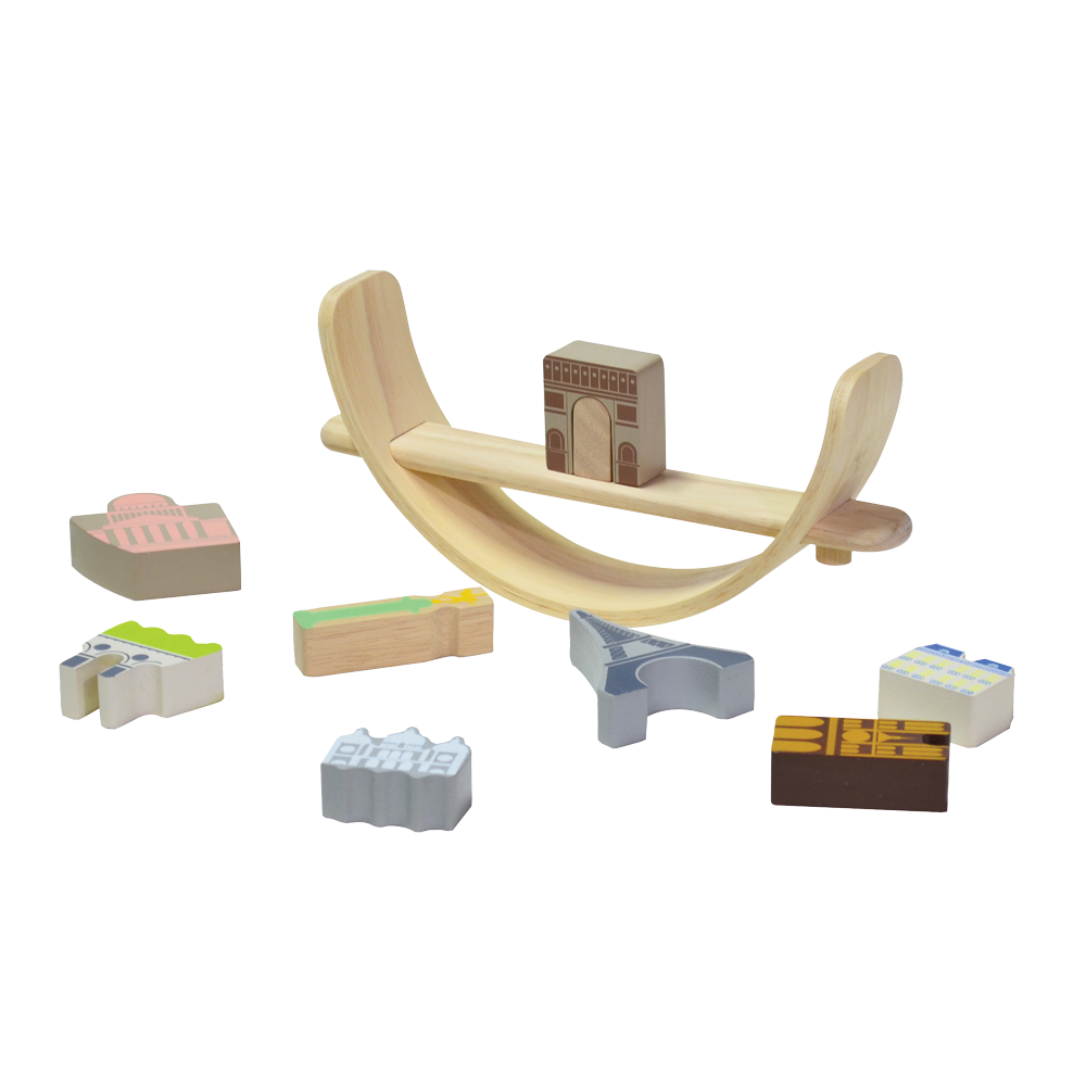 A wooden balancing toy set representing a Paris cityscape, with various colored pieces shaped as famous landmarks and a beige crescent base.