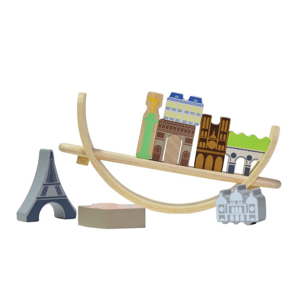 A wooden balancing toy set representing a Paris cityscape, with various colored pieces shaped as famous landmarks and a beige crescent base.