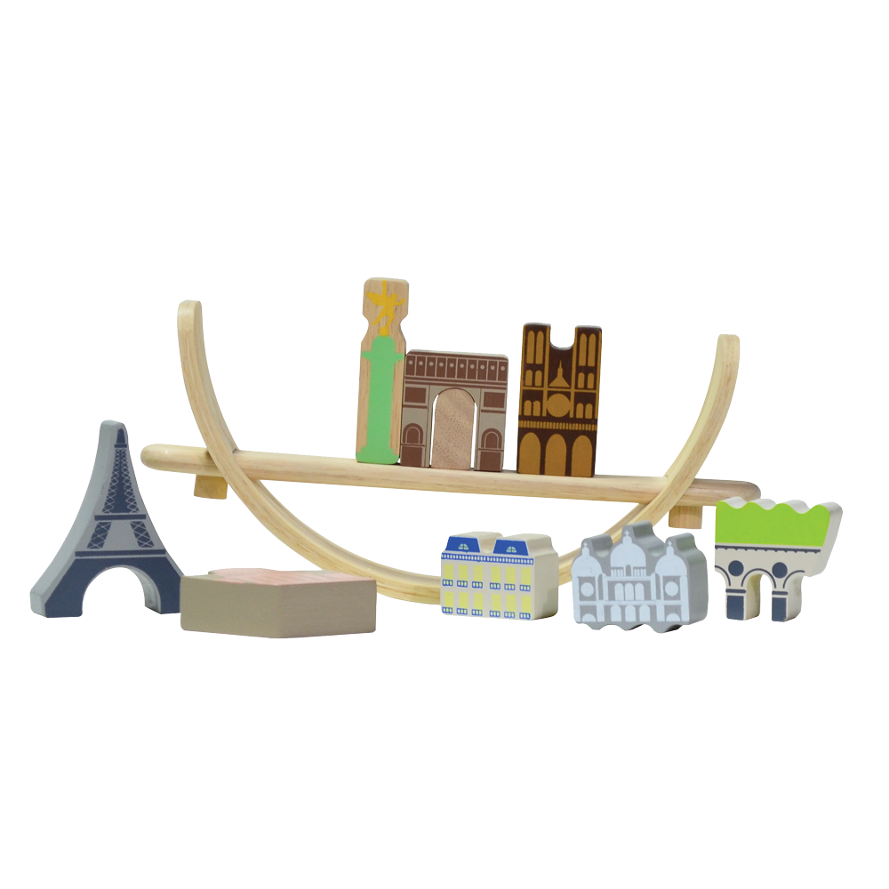A wooden balancing toy set representing a Paris cityscape, with various colored pieces shaped as famous landmarks and a beige crescent base.