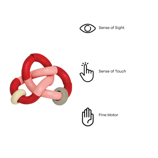 A colorful bendy rattle toy with red, pink, and white parts connected by knots.