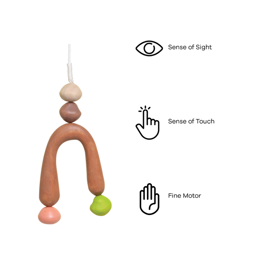 A colorful baby mobile with geometric shapes in brown, pink, green, and blue colors.