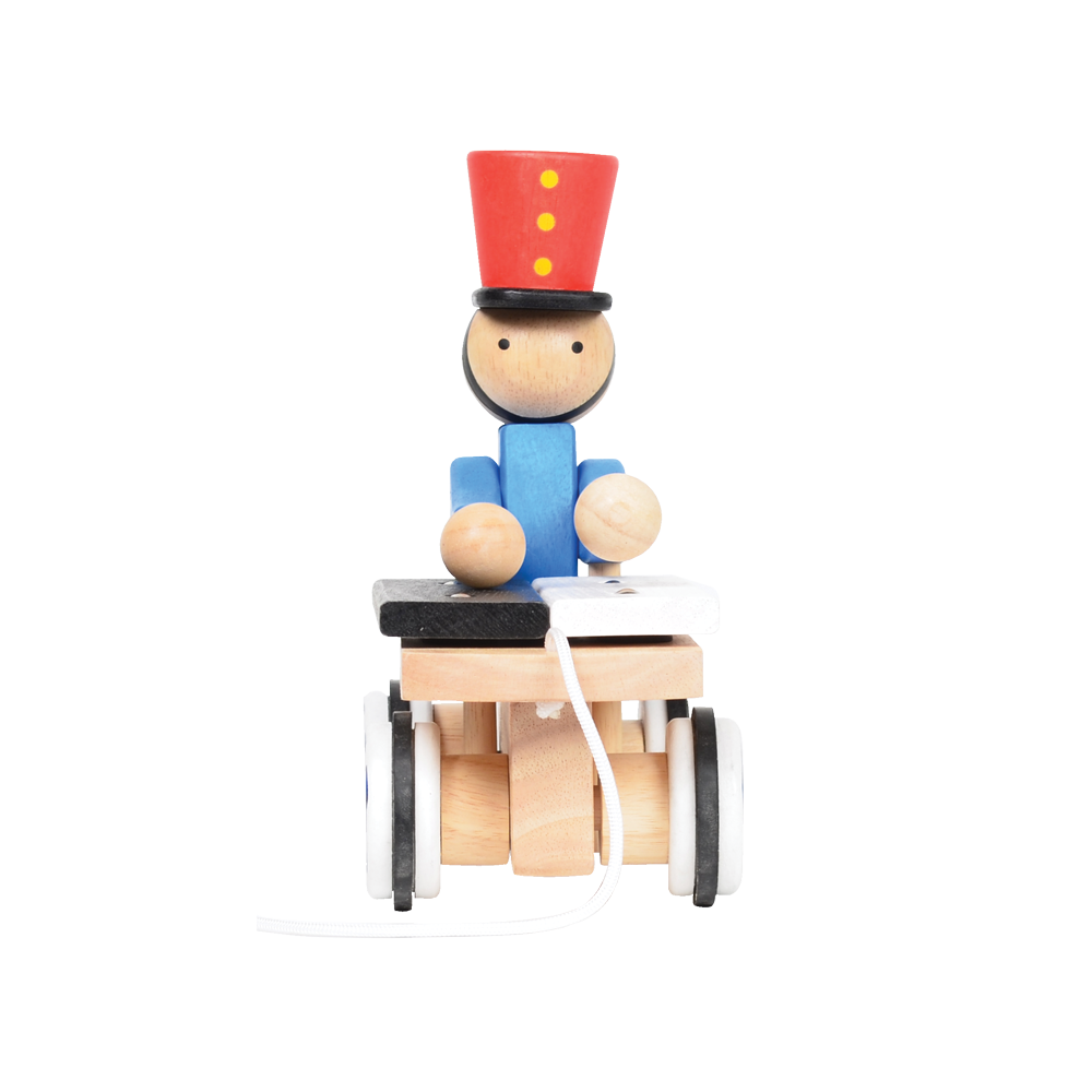 A wooden pull-along toy featuring a character resembling Pinocchio with a red hat, red jacket, attached to a small wooden xylophone on wheels with a red and white zig-zag pattern.