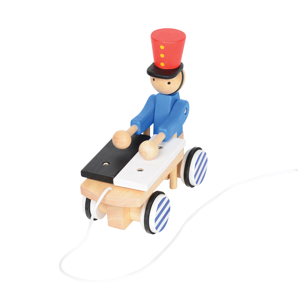 A wooden pull-along toy featuring a character resembling Pinocchio with a red hat, red jacket, attached to a small wooden xylophone on wheels with a red and white zig-zag pattern.